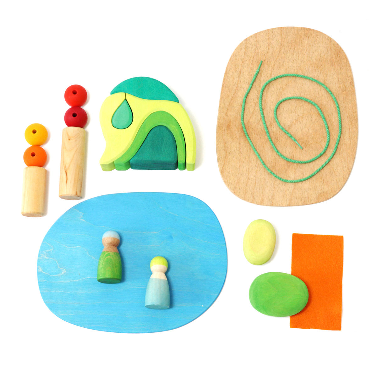 Pieces of the Grimm's plastic-free small world toy set laid out on a white background