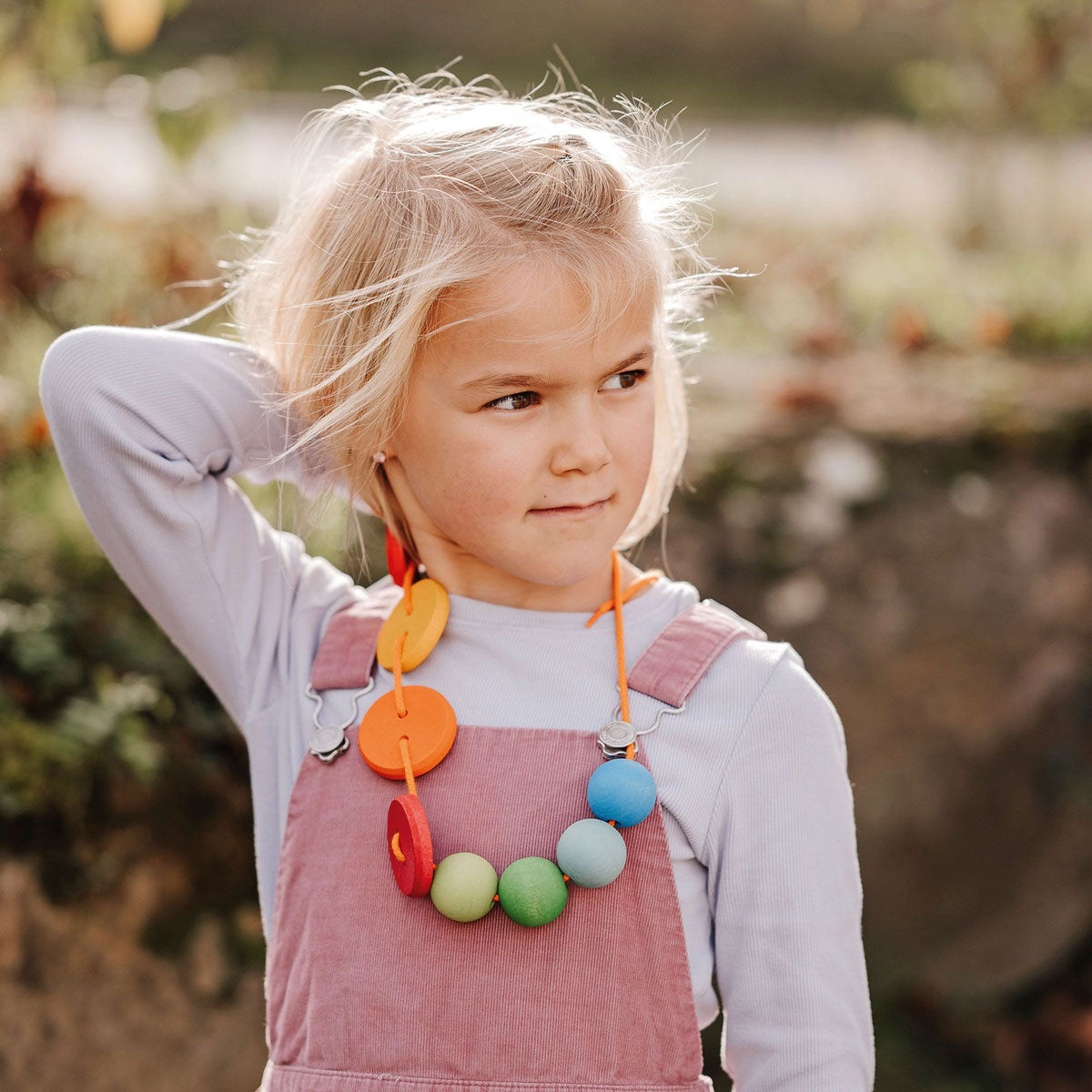 with an orange piece of string over her mouth