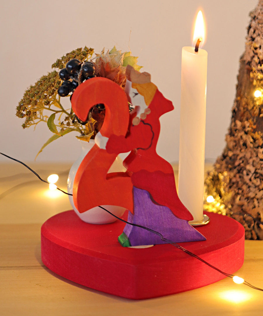 Grimm's Large Red Heart Celebration Ring with a number 2 decorative figure, a decorative vase and a candle. 