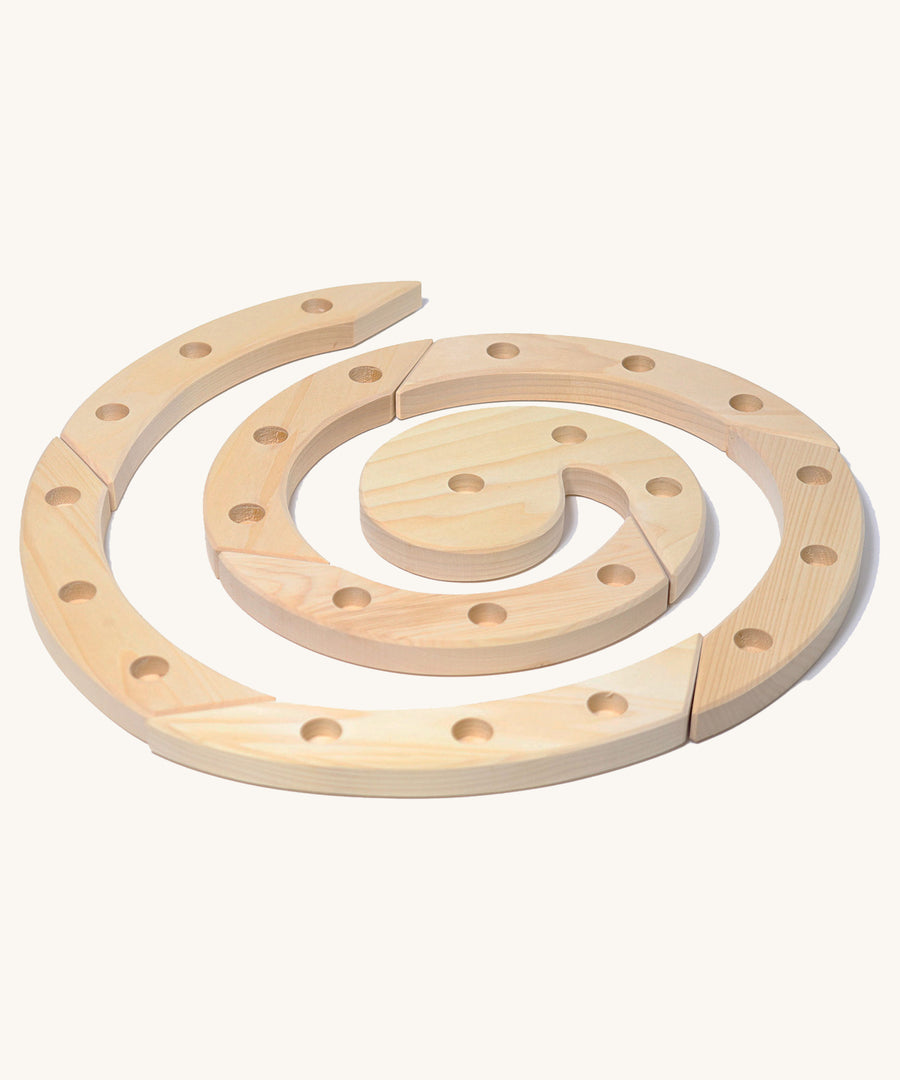 Grimm's Natural Wooden Spiral celebration ring n a plain background. 