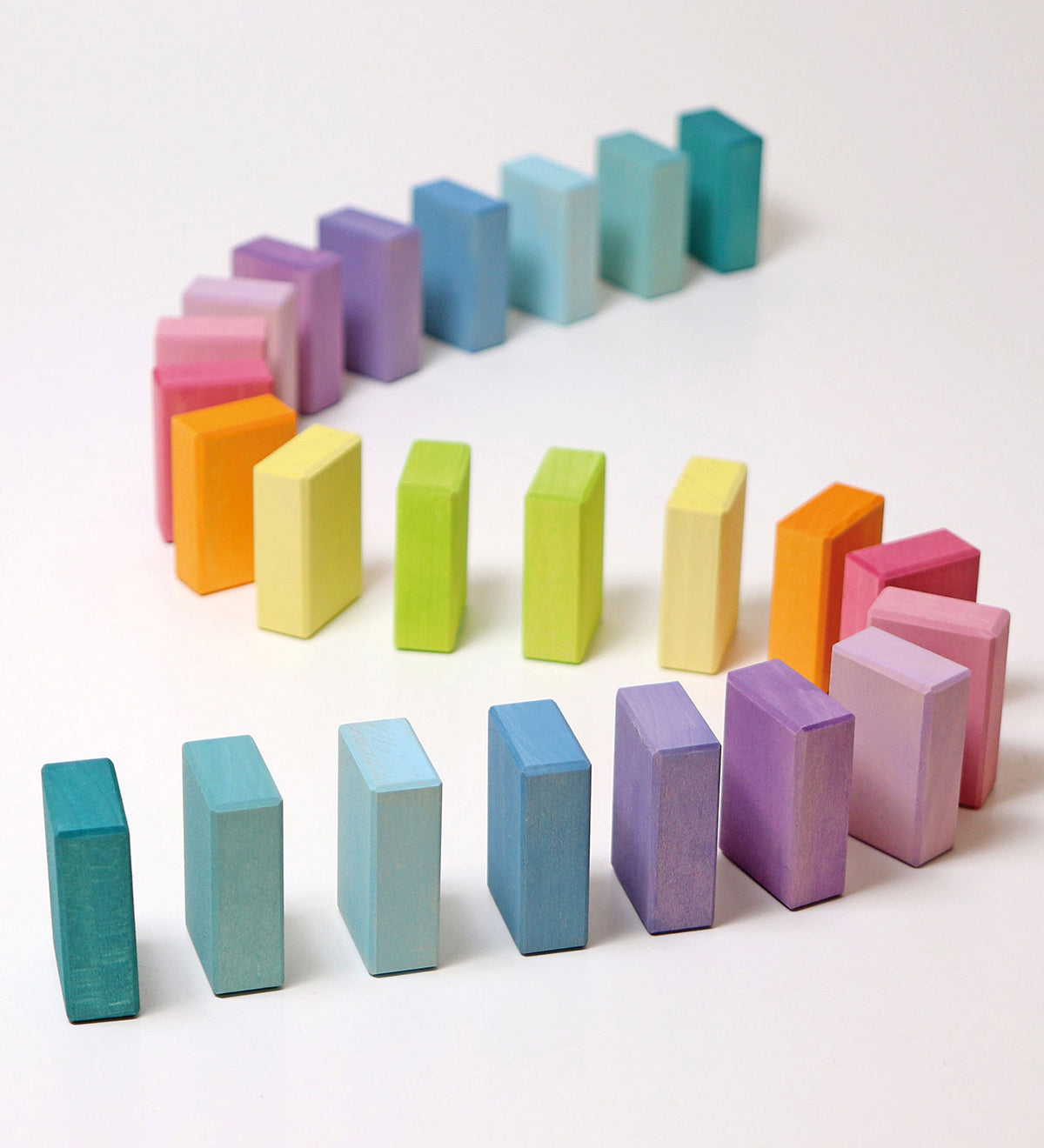 Grimms Wooden Pastel Duo Blocks lined up in an S shape line like dominoes