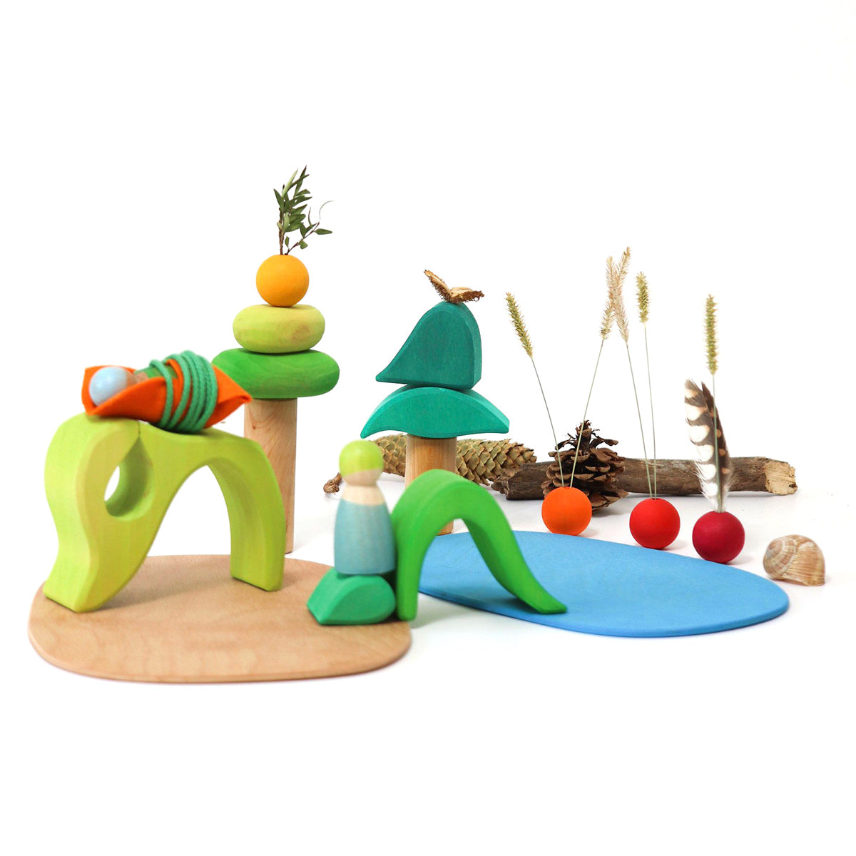 Grimm's wooden Waldorf small world play toy set laid out on a white background with some shells