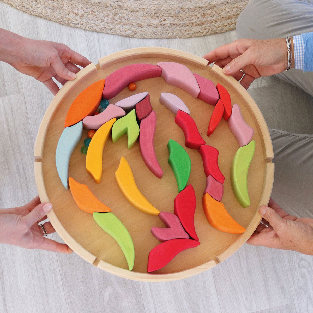 Close up of a child holding the plastic-free Grimm's Lara building blocks in a flower shape