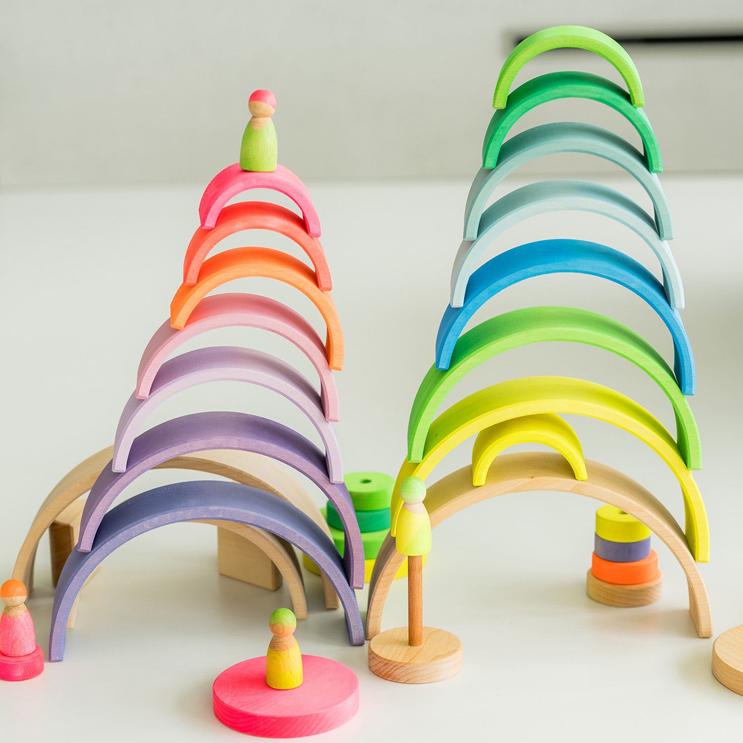 Grimm's 10-Piece Rainbow - Neon Green. A child plays in his house