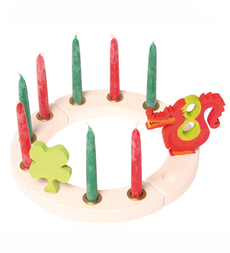 Grimm's White 12-Hole Celebration Ring with red and green candles, a four leafed clover and number figures. 