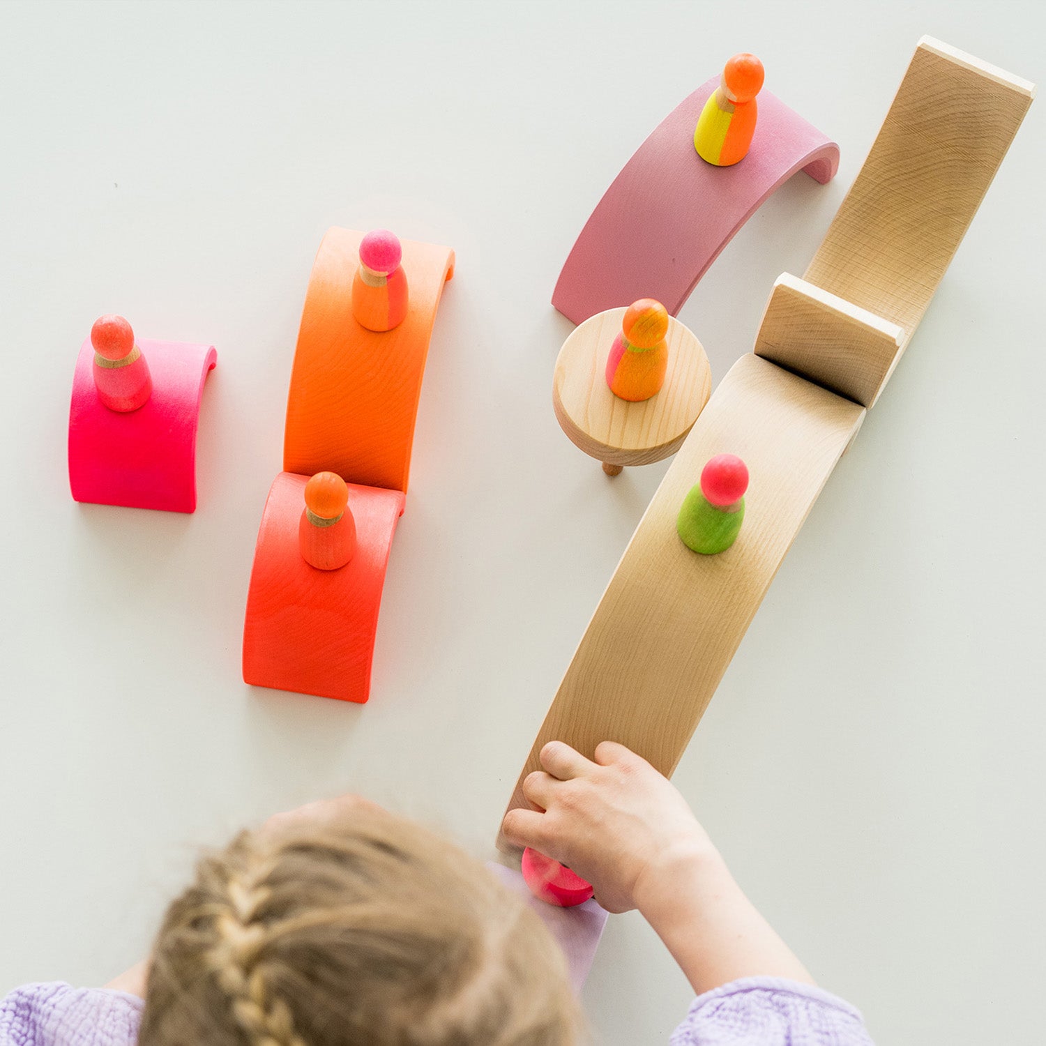 Grimm's Friends - Neon Pink - The peg dolls sit on a shelf in a home environment.