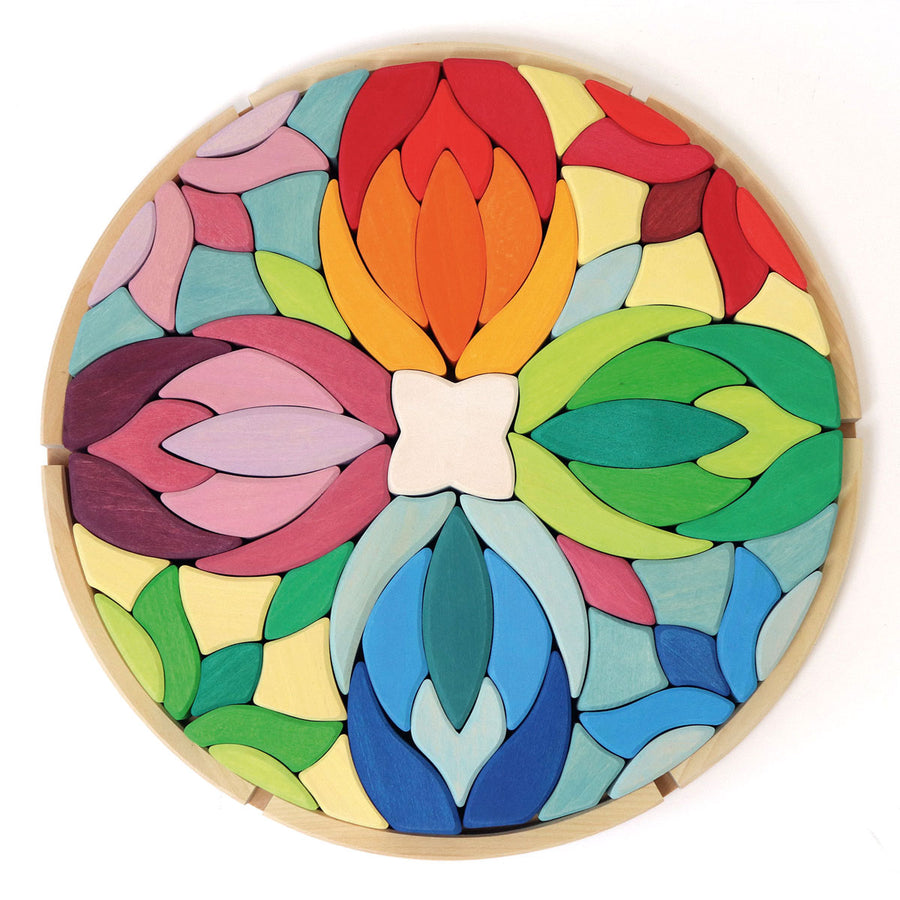 Grimms kids Lara wooden mandala toy blocks in their round wooden base on a white background