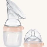 Generation 3 160ml Breast Pump and Baby Bottle Top Set, in peach on a cream background. This set come with the Haakaa Gen. 3 Silicone Breast Pump and Baby Bottle Top.