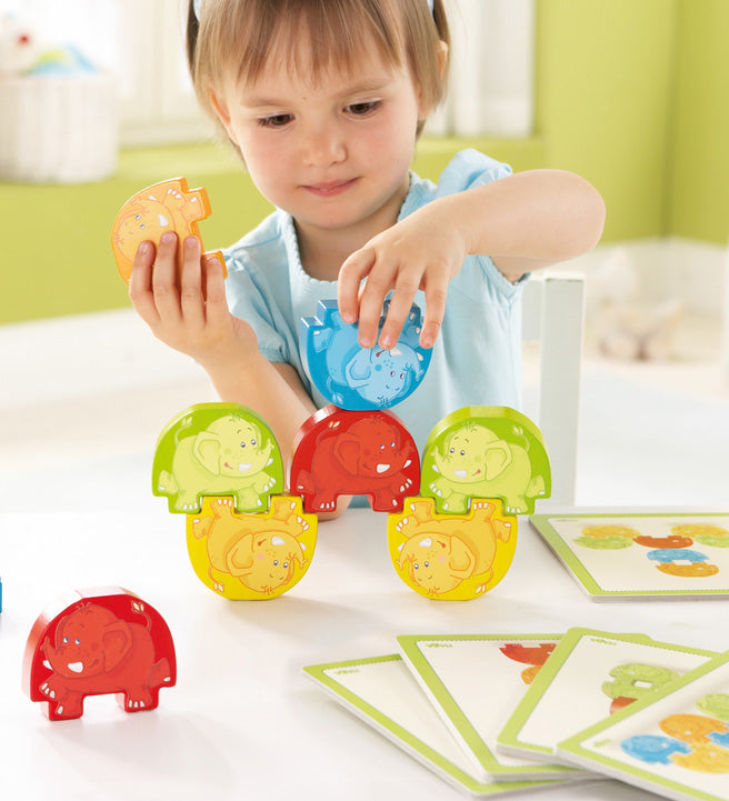 A child playing with the Haba stacking elephants game 