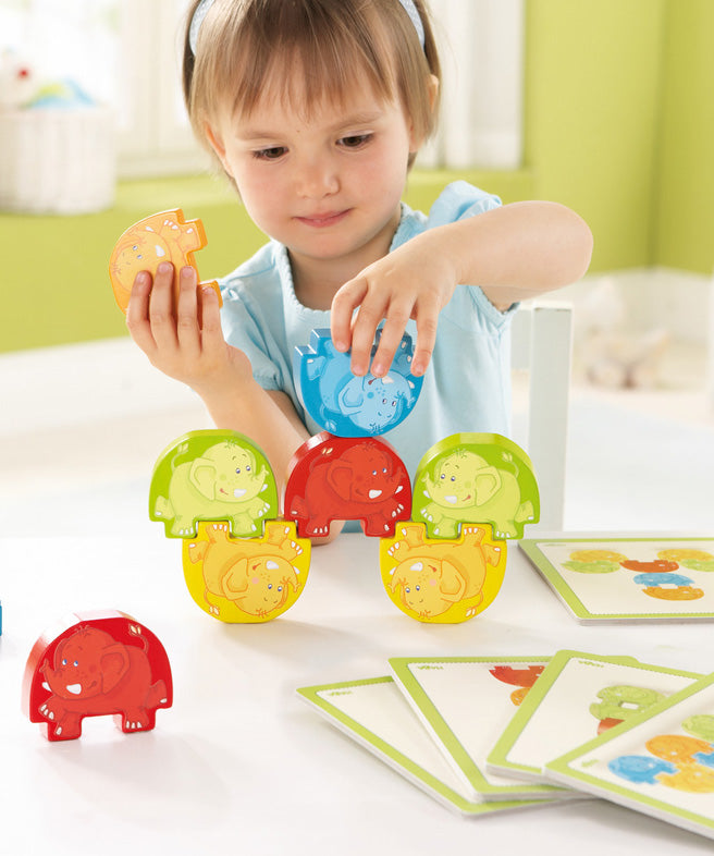 A child playing with the Haba stacking elephants game 