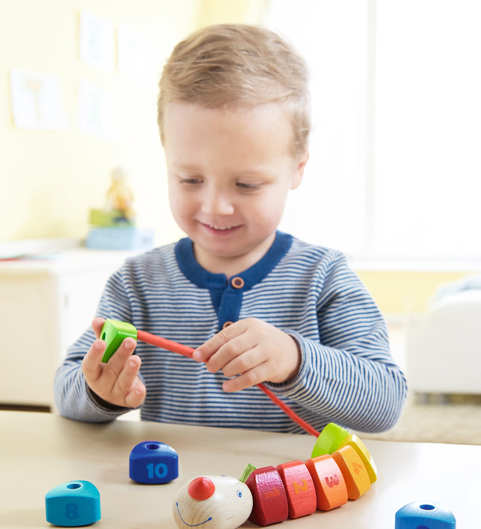 A child happily playing with the HABA number dragon