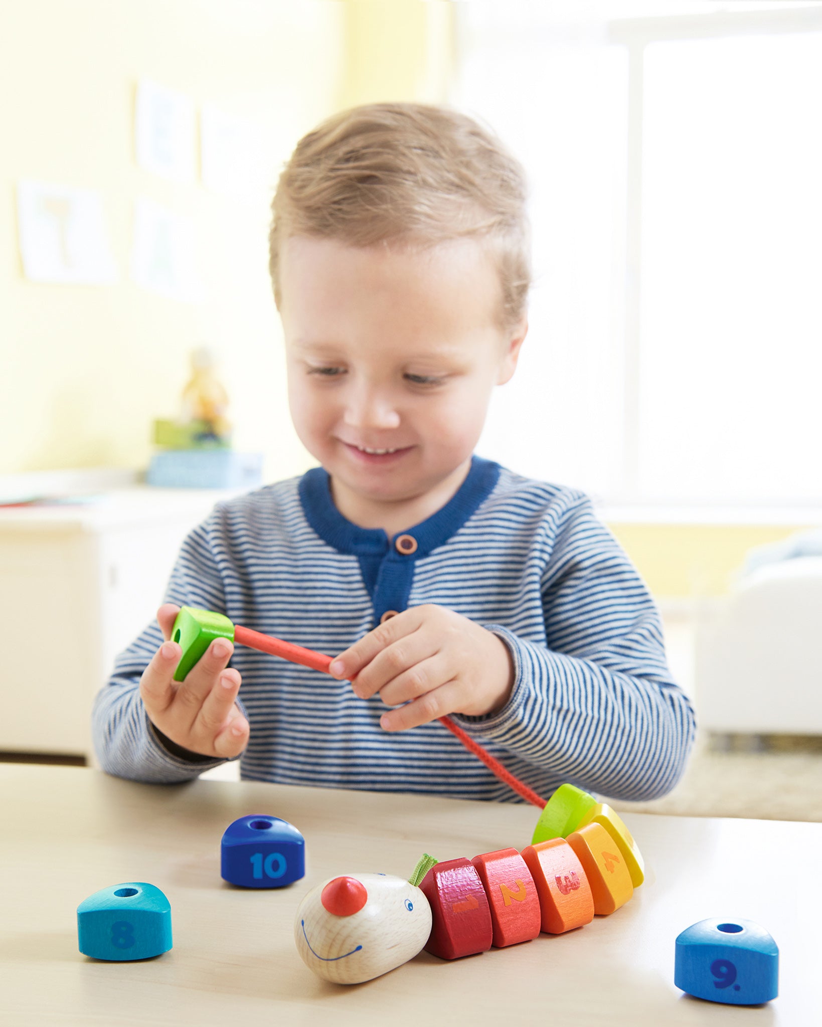 A child happily playing with the HABA number dragon