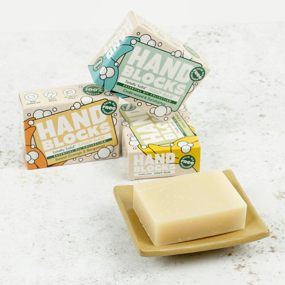 Hand Blocks Essential Oil Hand Soap Bar and Box - Cedarwood & Eucalyptus on a ceramic soap dish