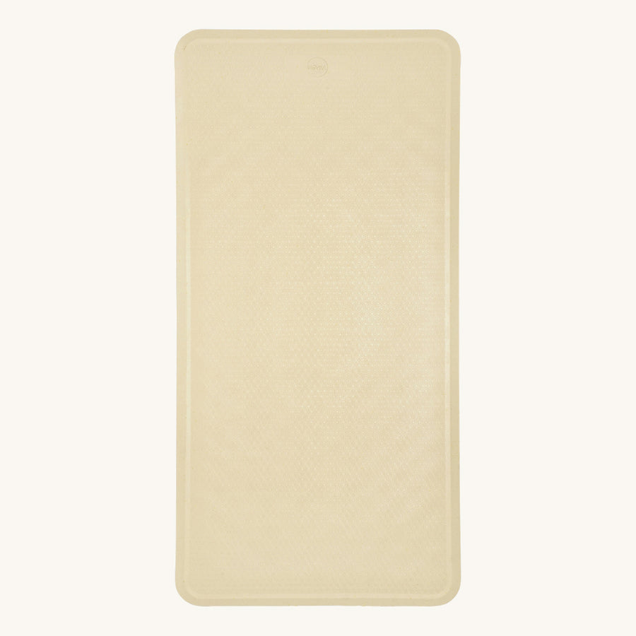 Hevea natural rubber bath mat in the sand colour on a beige background