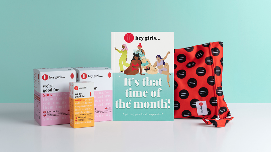 A Hey Girls 'My First Period Kit' containing pads, tampons, and a washbag