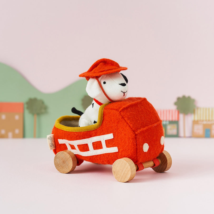 Olli Ella Holdie Dog-go Chief in a red felt fire truck with wooden wheels