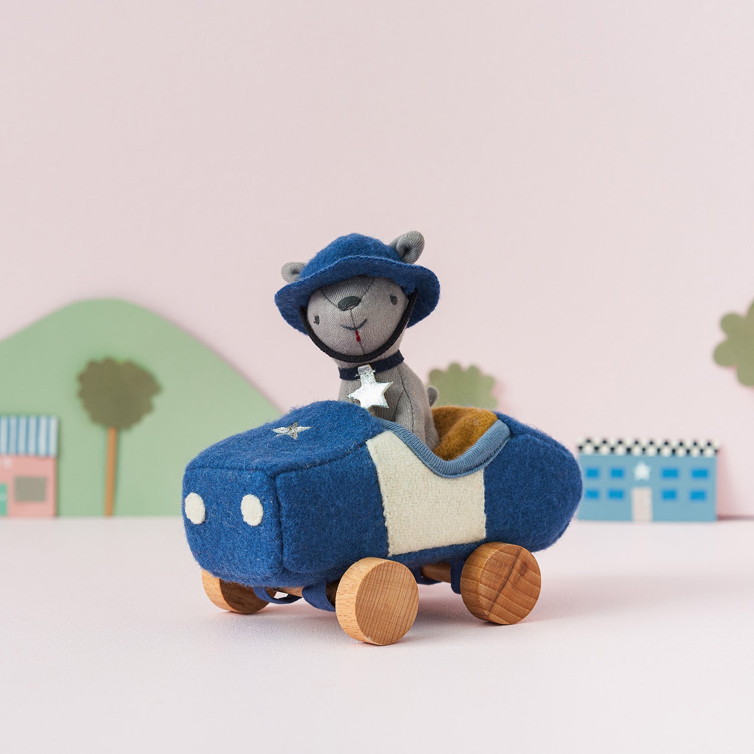 Olli Ella Holdie Dog-go Officer in a blue felt police car with wooden wheels