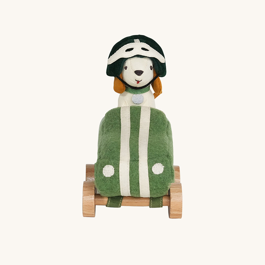 Olli Ella Holdie Dog-go Racer Boy sat next to a green felt racing car with wooden wheels and white stripes