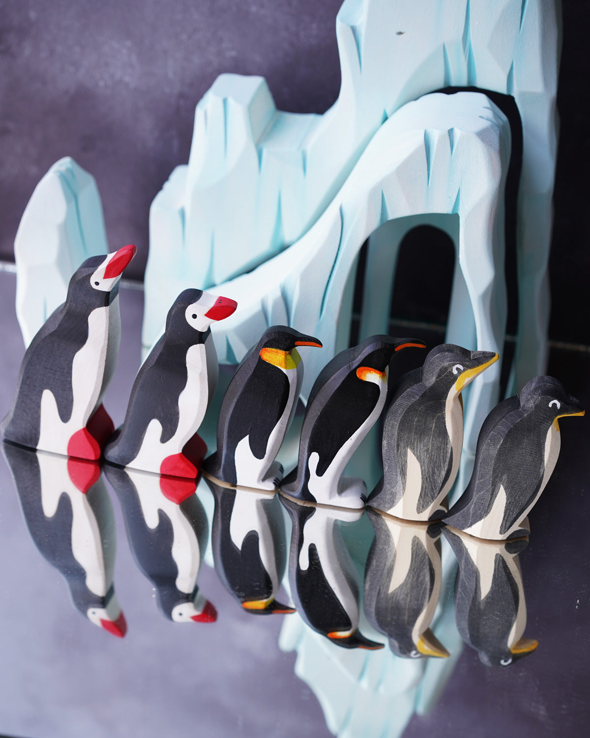 Bumbu and Ostheimer penguin figures lined up with a dark coloured background behind