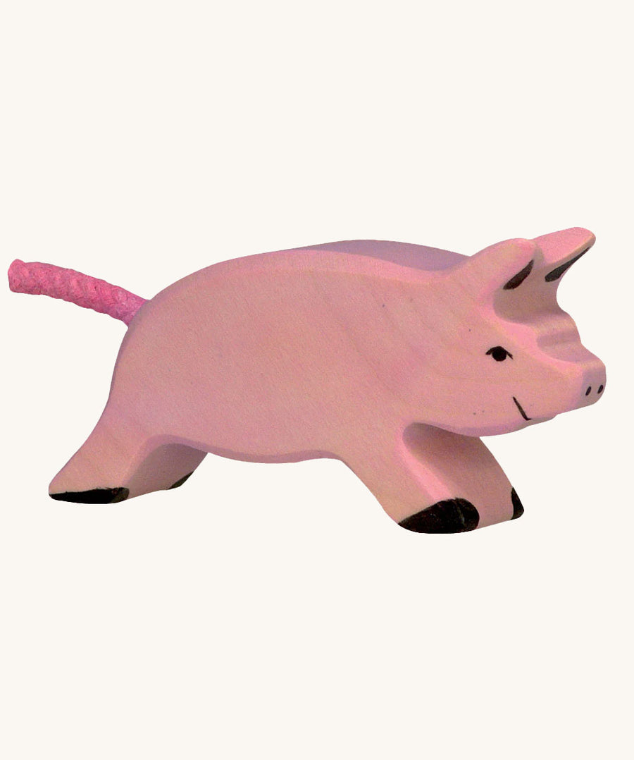 Holztiger Running Piglet Toy on a plain background. 