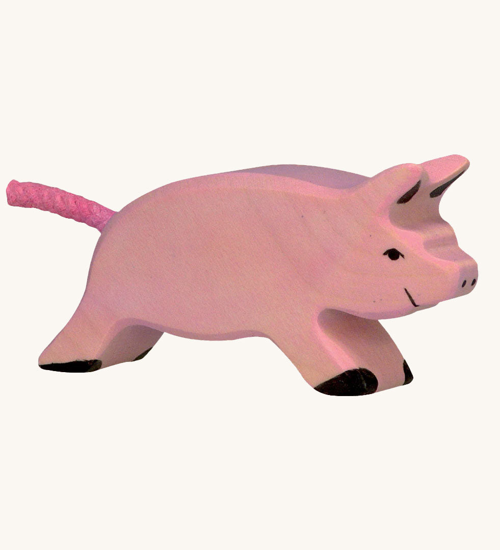 Holztiger Running Piglet Toy on a plain background. 