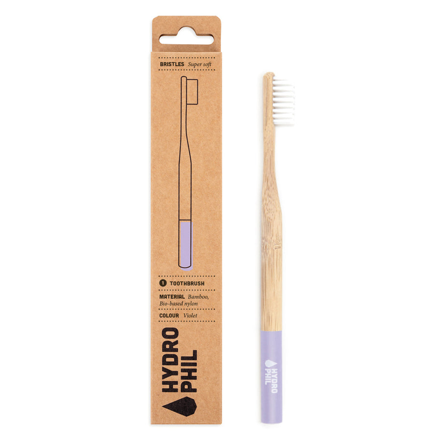 Hydrophil Super Soft purple bamboo toothbrush on a white background.