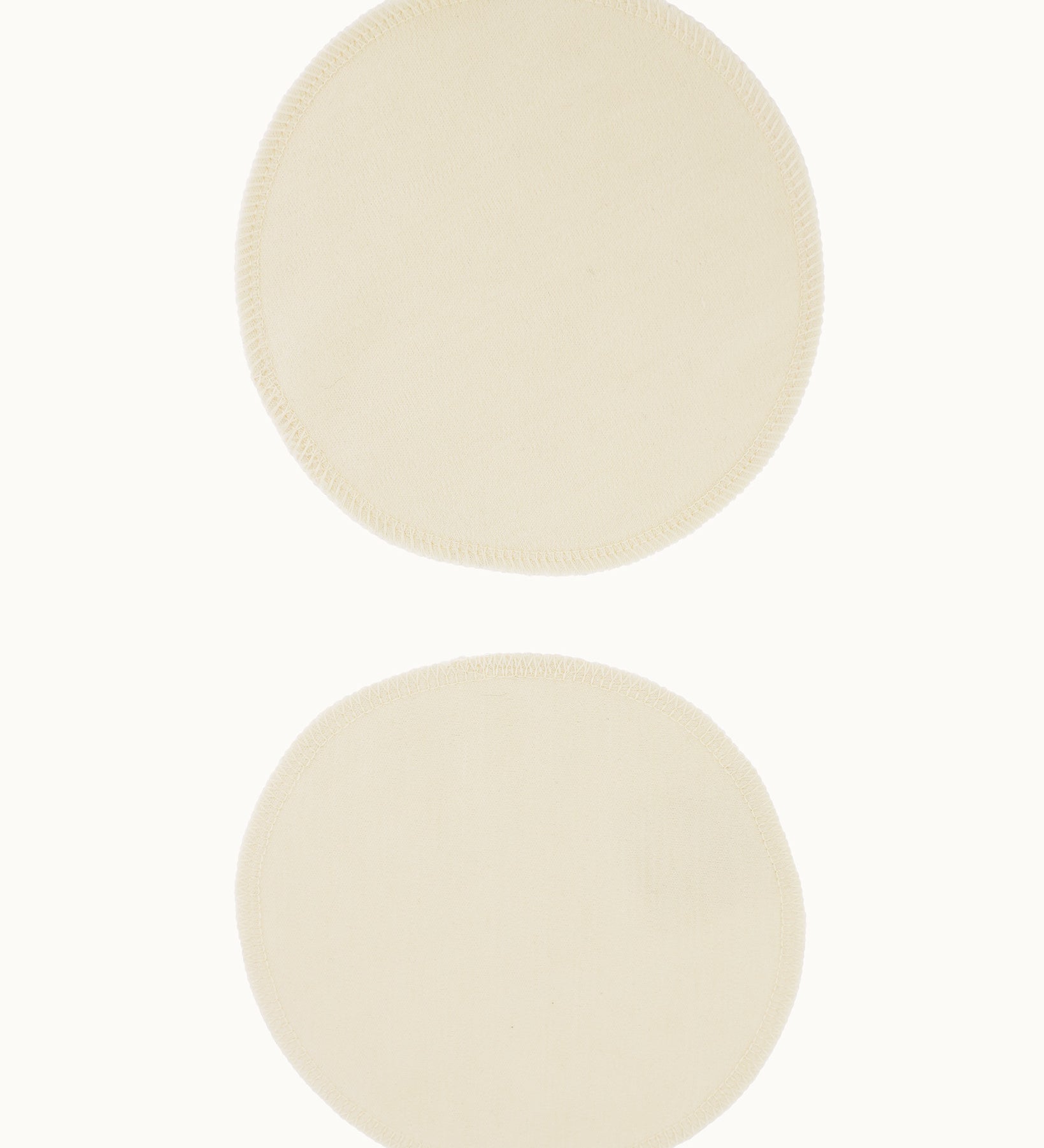 A pair of Imse Merino Wool Breast Warmer Pads pictured on a plain background