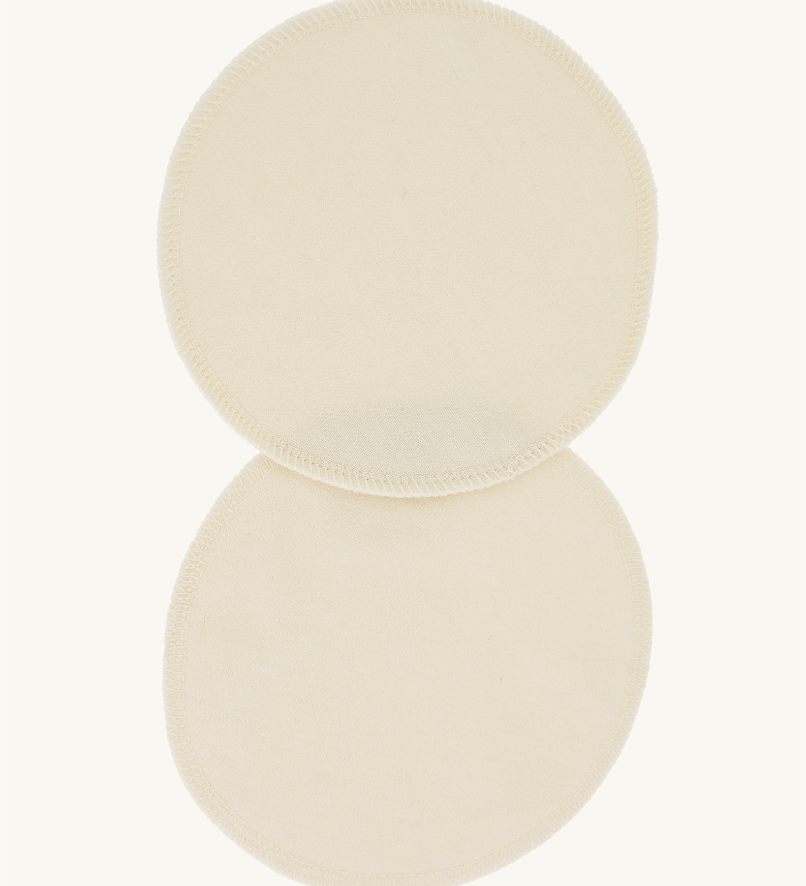 A pair of Imse Merino Wool Breast Warmer Pads pictured on a plain background