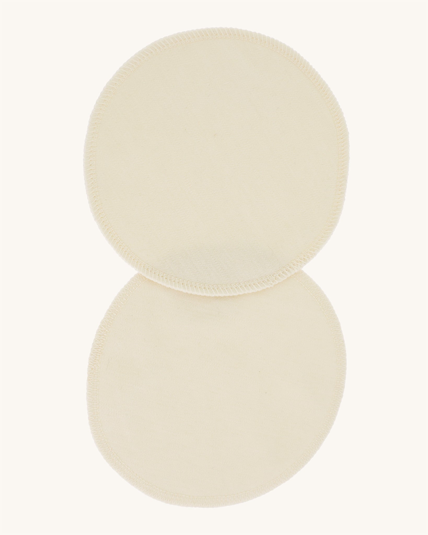 A pair of Imse Merino Wool Breast Warmer Pads pictured on a plain background