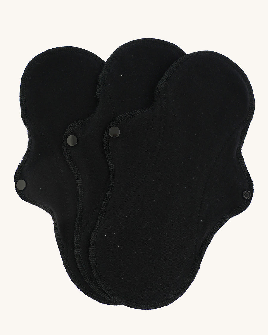 Imse Vimse black coloured Active Regular reusable Period Pads pictured on a plain background