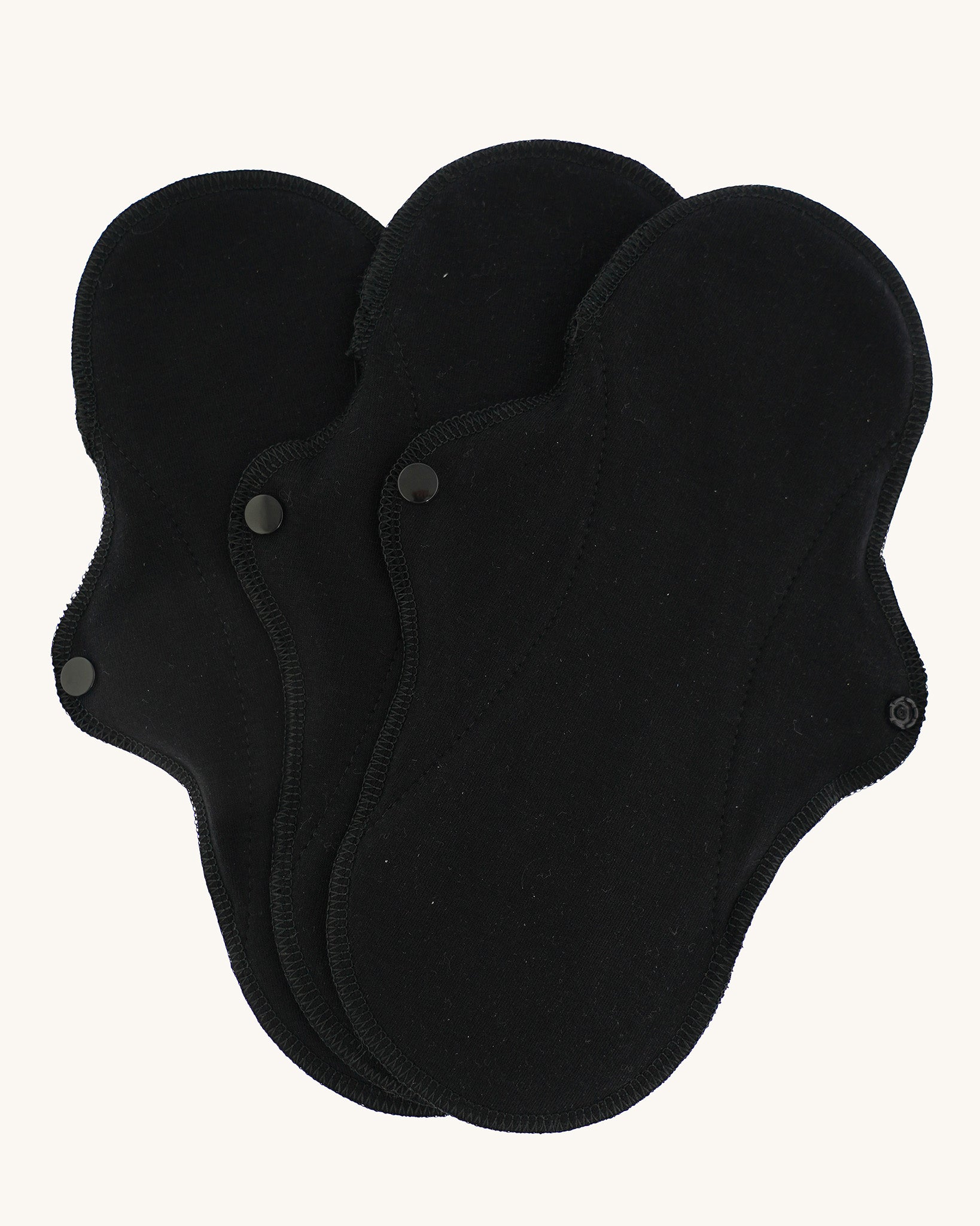 Imse Vimse black coloured Active Regular reusable Period Pads pictured on a plain background