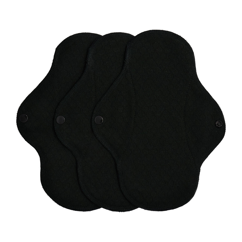 3 black Imse Vimse small reusable period pads on a white background