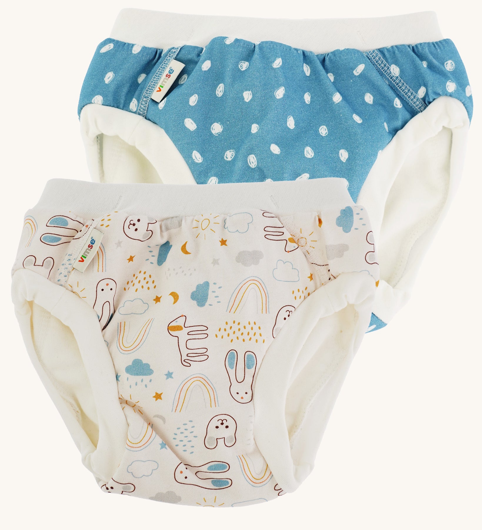 Imse Vimse Blue/Teddy Training Pants 2-Pack - Junior 16-20 kg. Two comfortable Cotton reusable training pants. The one on the left is blue with white scribbled sports, and the one on the right is white with colourful rabbits, bears, dogs, rainbows, clouds