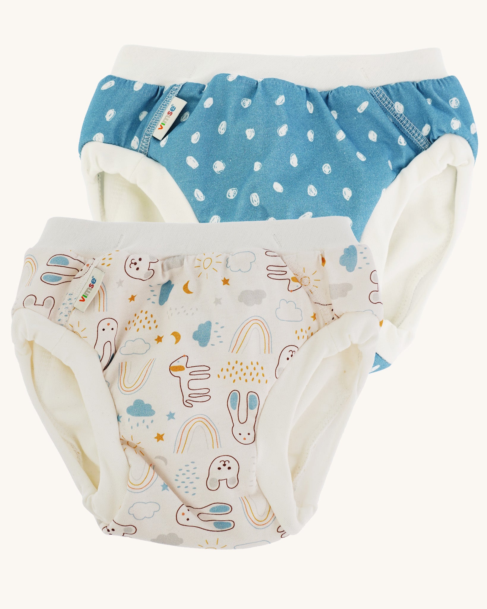 Imse Vimse Blue/Teddy Training Pants 2-Pack - Junior 16-20 kg. Two comfortable Cotton reusable training pants. The one on the left is blue with white scribbled sports, and the one on the right is white with colourful rabbits, bears, dogs, rainbows, clouds