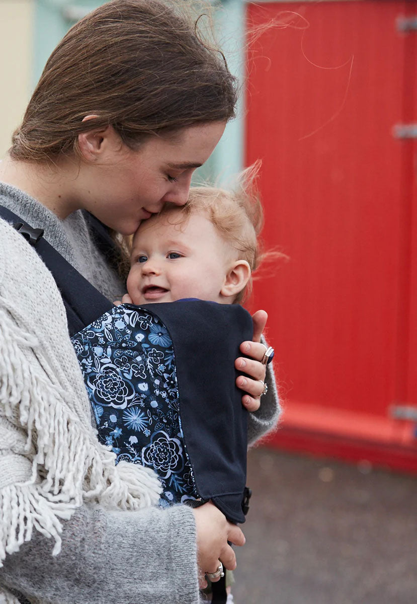 person babywearing using an Integra baby carrier with Copenhagen flowers print