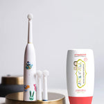 Jack N' Jill Fluoride-Free Strawberry Toothpaste 200g pictured next to buzzy brush toothbrush