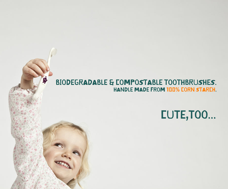 Child holding a Jack N Jill Bio Toothbrush up in the air next to a quote reading