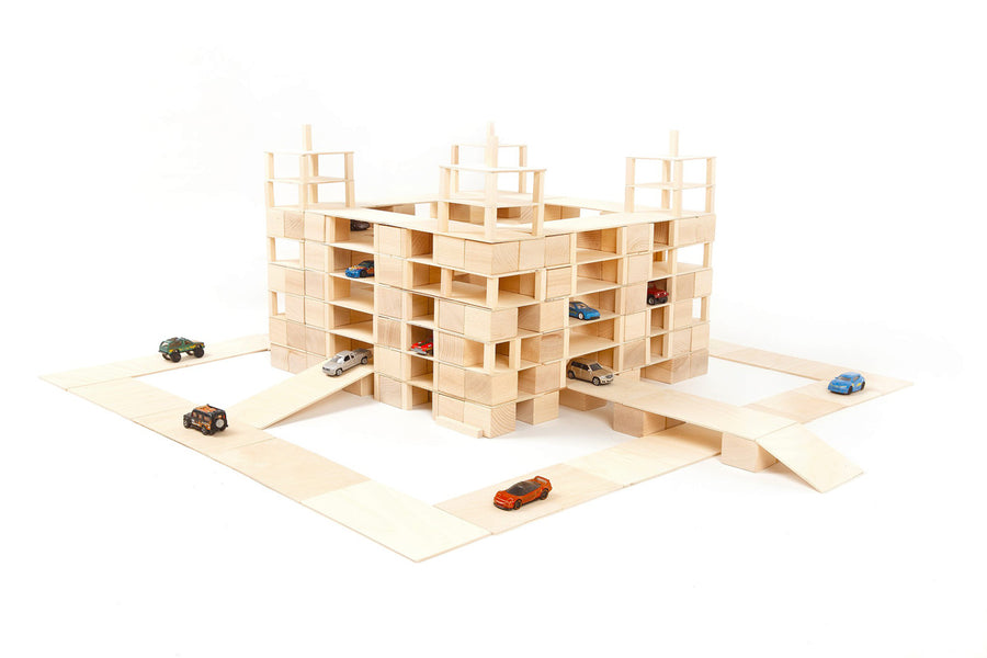 Just blocks handmade wooden building blocks stacked into a carpark shape on a white background