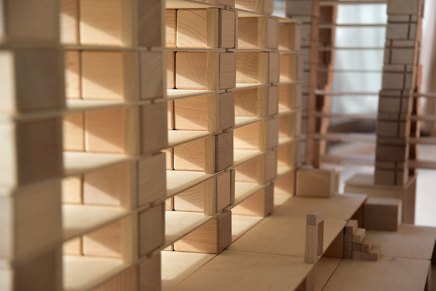 Close up of the Just Blocks handmade wooden shapes stacked in a row of neat towers