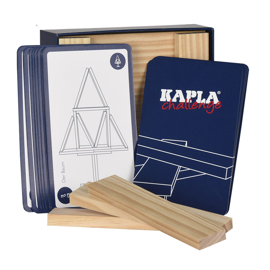 Cards from the Kapla natural wooden building game stood up against the challenge box on a white background