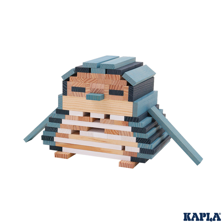 Kapla blue and natural wooden toy blocks stacked into the shape of a penguin on a white background