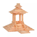 Kapla Waldorf building block toys stacked in the shape of a temple on a white background