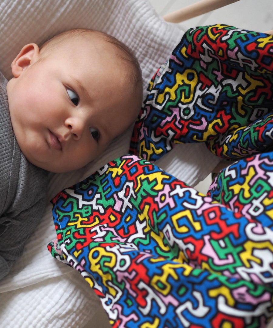 A closer look at the colours and shapes on the Etta Loves X Keith Haring Extra Large Organic Cotton Baby Muslin Square - Brazil