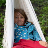 A child wearing the Little Green Radicals Kids Organic Cotton Blue Clouds Loose Fit Short Sleeve Henley Top with a striped blue shirt on top. 