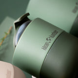 Close up of a dark green Klean Kanteen insulated lowball cup on a green background