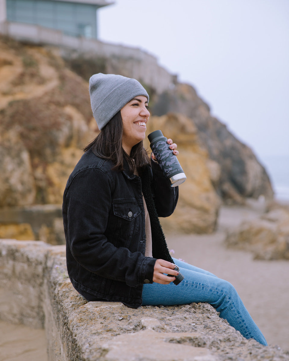 Woman sat on a stone wall