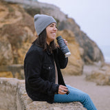 Woman sat on a stone wall