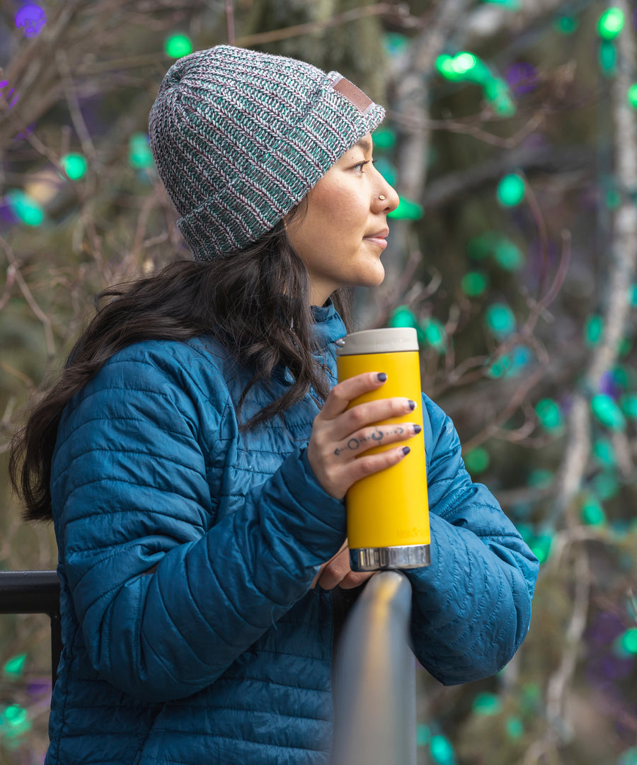 A person holding a Klean Kanteen 16oz TKWide in aSunset yellow colour with taupe Cafe cap. 