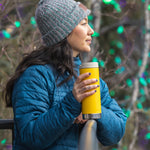 A person holding a Klean Kanteen 16oz TKWide in aSunset yellow colour with taupe Cafe cap. 