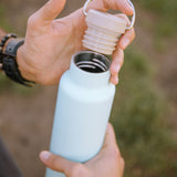 Close up of hands holding the Klean Kanteen 20oz insulated metal drinks bottle 